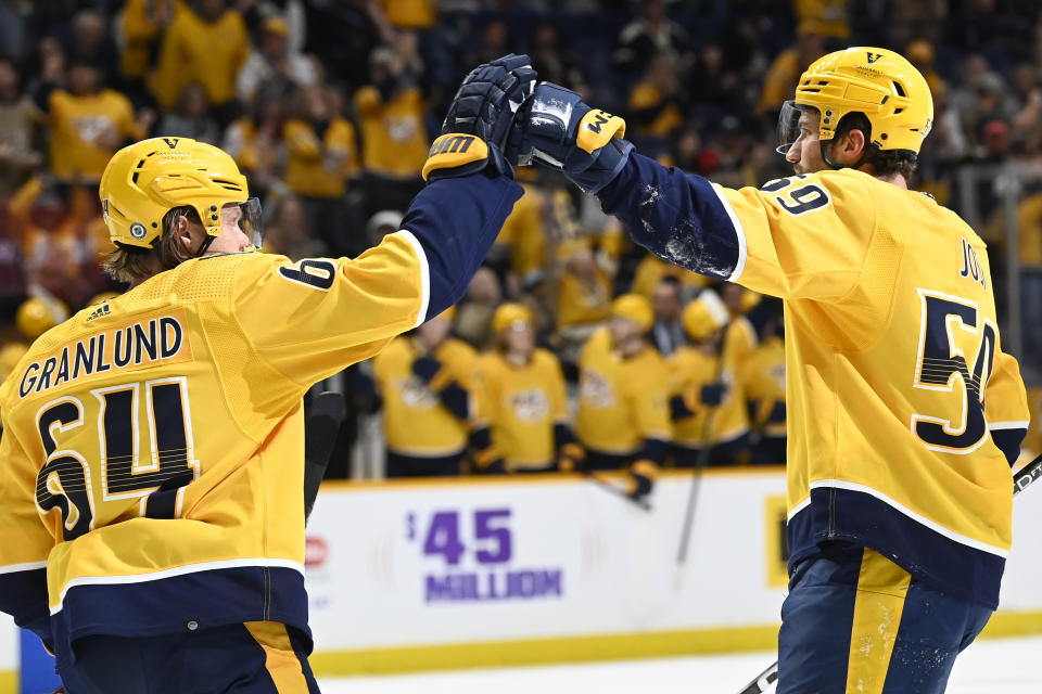 Nashville Predators defenseman Roman Josi celebrates with center Mikael Granlund after Josi scored a goal against the Arizona Coyotes during the second period of an NHL hockey game, Monday, Feb.13, 2023, in Nashville, Tenn. (AP Photo/Mark Zaleski)