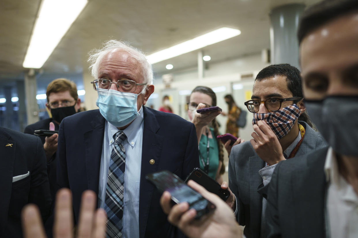 Sen. Bernie Sanders, I-Vt., chair of the Senate Budget Committee, is met by reporters during the vote to start work on a nearly $1 trillion bipartisan infrastructure package, at the Capitol in Washington, Wednesday, July 28, 2021.  (J. Scott Applewhite/AP) 
                                                                                                                                                                                                                                                                  