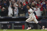 Atlanta Braves' Ozzie Albies celebrates after scoring the winning run on an RBI single by Atlanta Braves' Austin Riley in the ninth inning in Game 1 of baseball's National League Championship Series against the Los Angeles Dodgers Saturday, Oct. 16, 2021, in Atlanta. The Braves defeated the Dodgers 3-2 to take game 1. (AP Photo/Brynn Anderson)