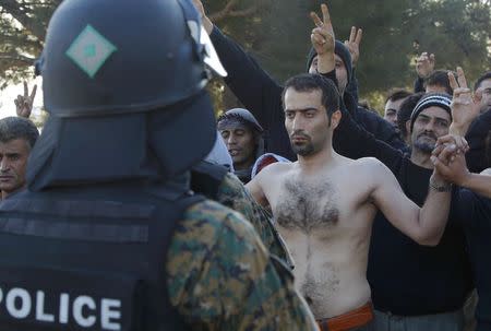 A migrant with his mouth sewn shut in protest demonstrate among the others at the border with Greece near the village of Gevgelija, Macedonia November 23, 2015. REUTERS/Ognen Teofilovski