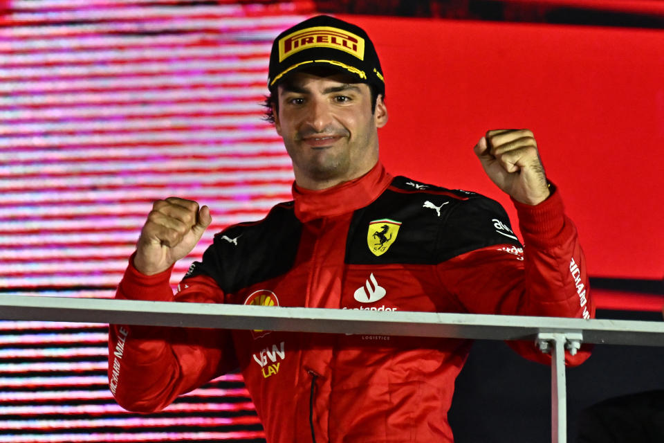 Ferrari driver Carlos Sainz celebrates on the podium after winning the 2023 Formula 1 Singapore Grand Prix. 