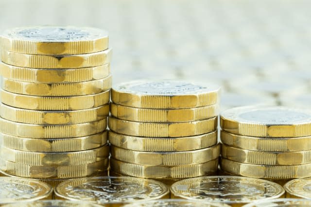 British money, three pound coins descending stacks.