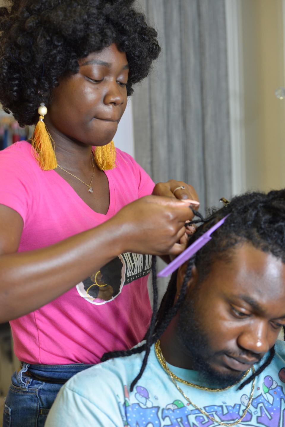 Keniqua Smith, of Divas Beauty Studio in Hyannis, calls her own natural hair her "crown." Smith said she's dismayed when her clients worry about how their hair will affect their ability to be hired for office positions.