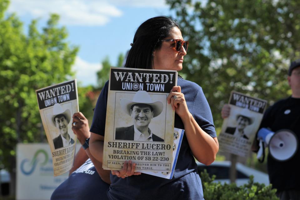 Jenny Hohman, a union representative from the AFSCME 1335 chapter, holds up a sign protesting Pueblo County Sheriff Lucero's request to delay negotiations during a demonstration outside the PCSO office on Wednesday, May 2, 2024.