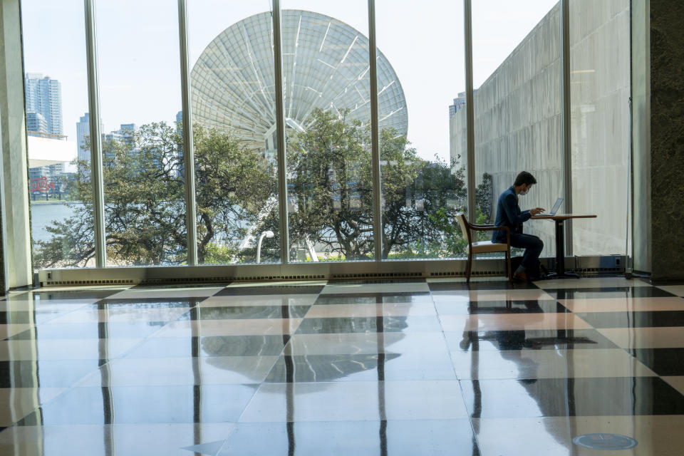 A member of the Irish delegations works on his computer in the main lobby of the United Nations headquarter, Monday, Sept. 21, 2020. (AP Photo/Mary Altaffer)