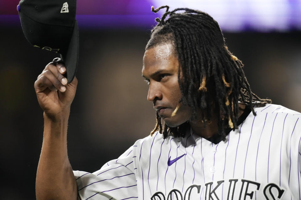 As fans applaud his effort, Colorado Rockies starting pitcher Jose Urena tips his cap in appreciation after being pulled following a single by San Francisco Giants' Brandon Crawford during the seventh inning of a baseball game Friday, Aug. 19, 2022, in Denver. (AP Photo/David Zalubowski)