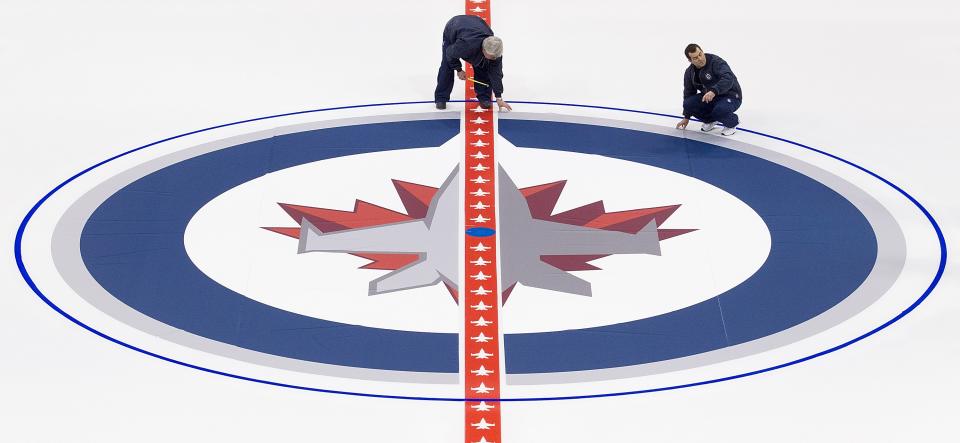 WINNIPEG, CANADA - JANUARY 8: Ice technicians install the Winnipeg Jets logo at centre ice at the MTS Centre on January 8, 2013 in Winnipeg, Manitoba, Canada. (Photo by Marianne Helm/Getty Images)