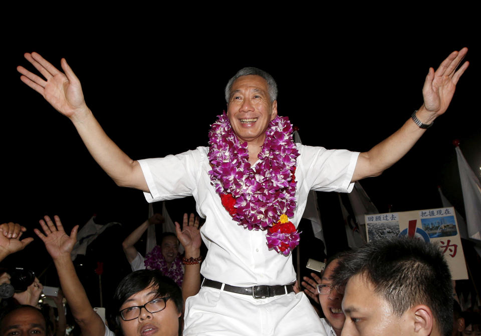 <strong>FILE PHOTO Singapore’s Prime Minister and Secretary-General of the People’s Action Party Lee Hsien Loong (C) celebrates with supporters after the general election results at a stadium in Singapore September 12, 2015. REUTERS/Edgar Su/File Photo</strong>