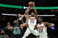 Phoenix Suns' Mikal Bridges (25) shoots against Boston Celtics' Derrick White, top left, and Al Horford (42) during the second half of an NBA basketball game, Friday, Feb. 3, 2023, in Boston. (AP Photo/Michael Dwyer)