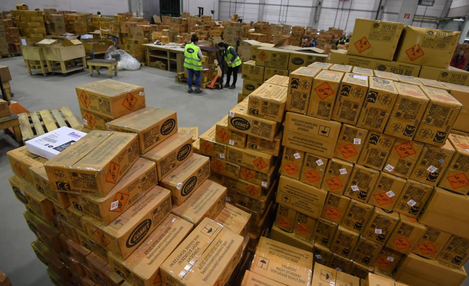 20 December 2018, Bremen, Bremerhaven: Employees of Comet Feuerwerk GmbH, a pyrotechnics company, prepare cartons with fireworks for New Year's Eve in the huge warehouses. The company's logistics department is currently in high spirits. Comet Fireworks makes up the bulk of its annual turnover in the last three working days in December. Photo: Carmen Jaspersen/dpa (Photo by Carmen Jaspersen/picture alliance via Getty Images)