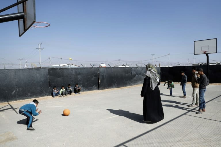 Syrian refugees play with a ball at the Zaatari camp which shelters some 80,000 Syrian refugees on the Jordanian border with war-ravaged Syria on March 28, 2017