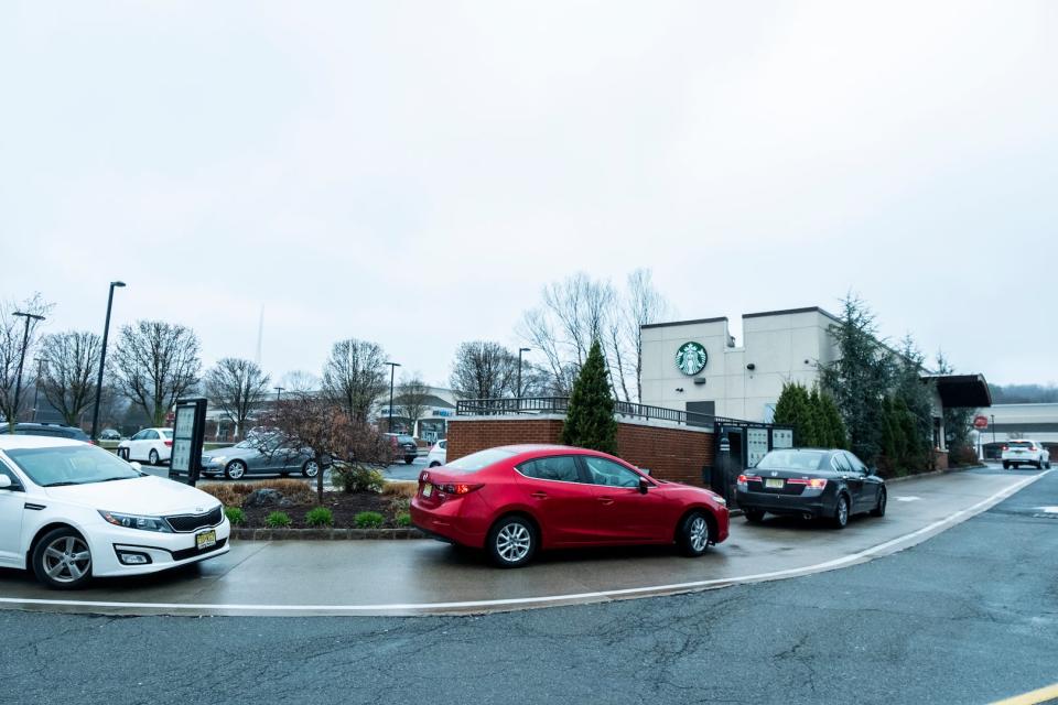 A line of cars waits at Starbucks Drive Thru 