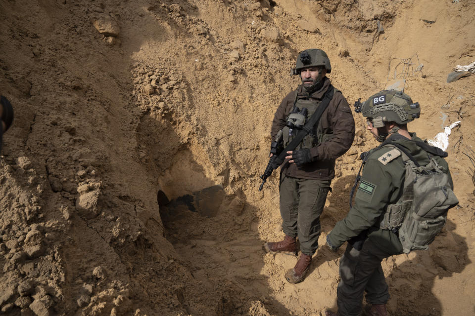Israeli Brigadier General Dan Goldfus, left, stands by a Hamas tunnel underneath a cemetery during the ground offensive on the Gaza Strip in Khan Younis, Saturday, Jan. 27, 2024. (AP Photo/Sam McNeil)