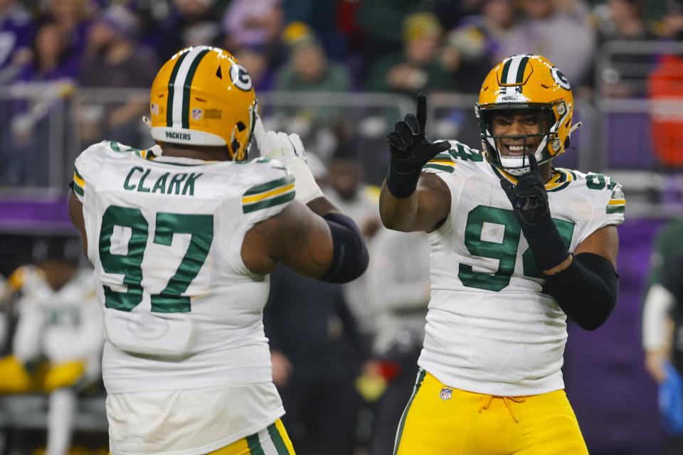 Green Bay Packers' Karl Brooks and Kenny Clark celebrates during the first half of an NFL football game against the Minnesota Vikings Sunday, Dec. 31, 2023, in Minneapolis. (AP Photo/Bruce Kluckhohn)