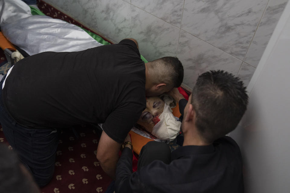 Mourners take the last look at the body of Salah Sawafta, 58 during his funeral at a mosque, in the West Bank city of Tubas, Friday, Aug. 19, 2022. Israeli forces shot and killed Sawafta during an arrest raid in the occupied West Bank on Friday, according to his brother, who said he was walking home when a bullet struck him in the head as Israeli forces clashed with Palestinian youths. (AP Photo/Nasser Nasser)