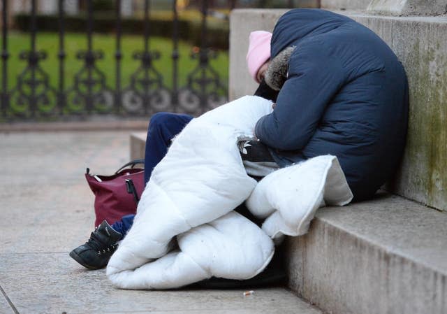 Homeless people sleep on the plinth of the Ferdinand Foch equestrian statue in Victoria, London