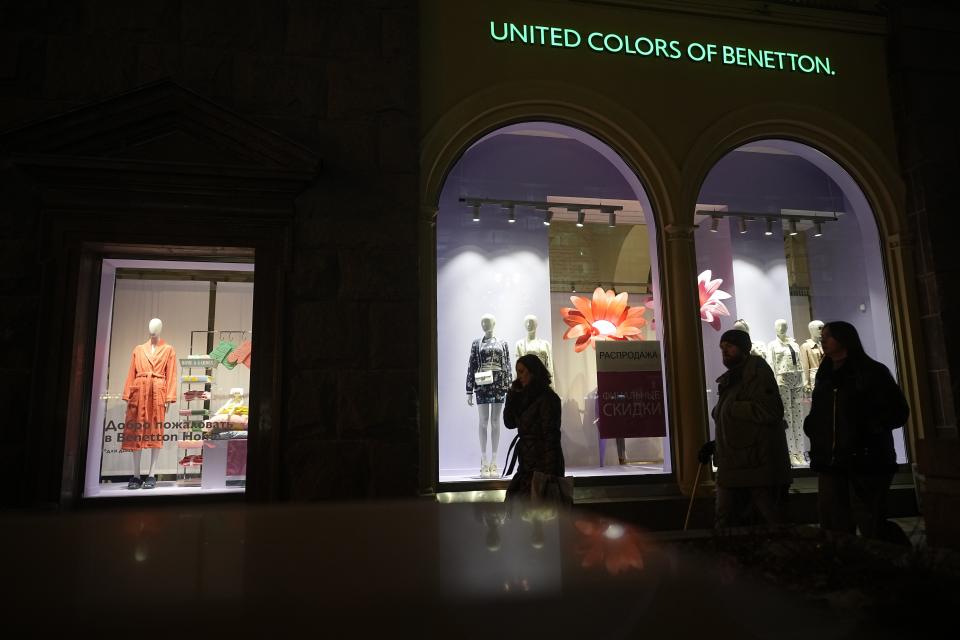 People walk past a United Colors of Benetton shop in Tverskaya street in Moscow, Russia, on Wednesday, March 6, 2024. When Russia invaded Ukraine, companies were quick to respond, some announcing they would get out of Russia immediately, others vowed to curtail sales and new investment. The economy's resilience in the face of bruising Western sanctions is a major factor behind President Vladimir Putin's grip on power in Russia. (AP Photo/Alexander Zemlianichenko)