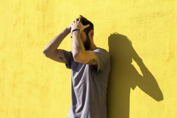 Young man combing his hair (iStock)