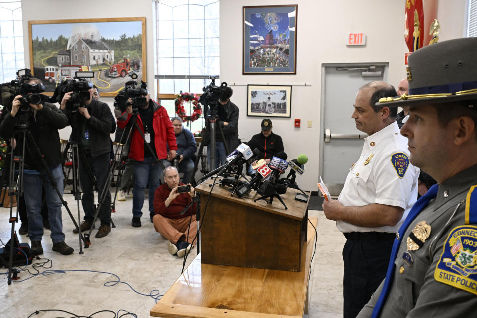 Somers Fire Chief John Roache, second from right, speaks at a news conference at the Somers Fire Department, Wednesday, Jan. 3, 2024, in Somers, Conn. Four children died Tuesday night in a fire that broke out in the two-family home. The children, ages 5, 6, 8 and 12, were found inside the house where 11 people lived, fire and town officials said. (AP Photo/Jessica Hill)