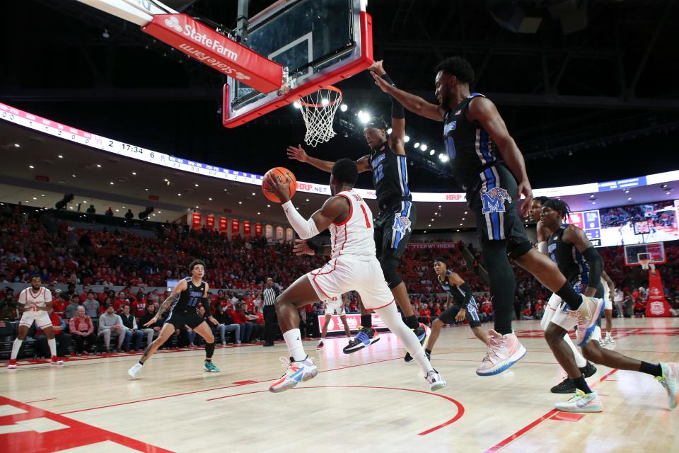 Feb 12, 2022; Houston, Texas, USA; Houston Cougars guard Jamal Shead (1) looks to pass against Memphis Tigers forward DeAndre Williams (12) and guard Alex Lomax (10) in the first half at Fertitta Center. Mandatory Credit: Thomas Shea-USA TODAY Sports