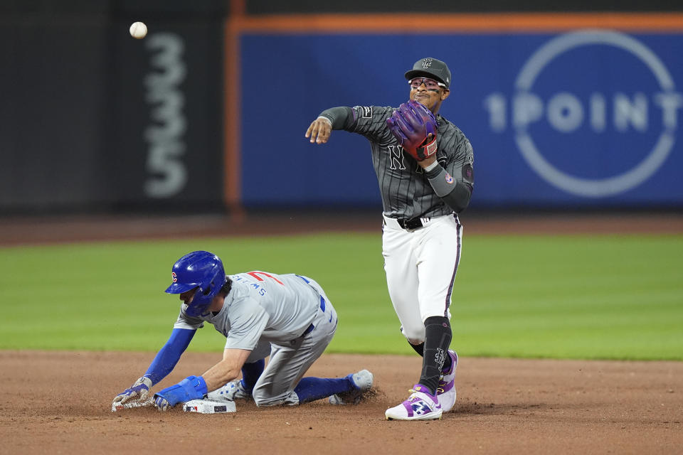 New York Mets' Francisco Lindor, right, throws to first base after forcing out Chicago Cubs' Dansby Swanson, left, during the eighth inning of a baseball game, Monday, April 29, 2024, in New York. Cubs' Matt Mervis was safe at first base on the play. (AP Photo/Frank Franklin II)