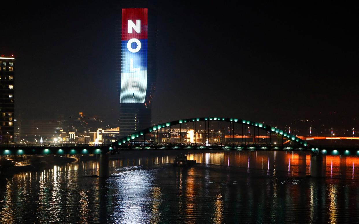 The word 'Nole', a nickname of Serbian tennis player Novak Djokovic, and the colours of the Serbian flag are illuminated at the Belgrade Tower in Serbia - GETTY IMAGES