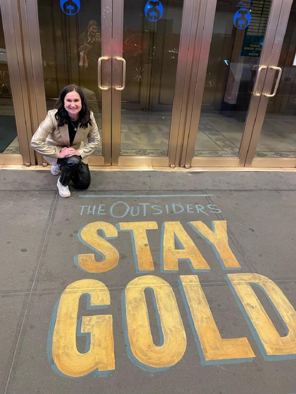 Oklahoma City native and co-producer Laura Galt poses outside the Bernard B. Jacobs Theatre on Broadway, where "The Outsiders" musical is playing. The stage adaptation of Tulsa writer S.E. Hinton's classic novel began its Broadway run with previews starting on March 16 ahead of the official opening night on April 11.