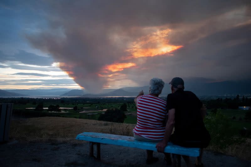 Couple view the newly ignited Mount Law wildfire from the waterfront in Kelowna