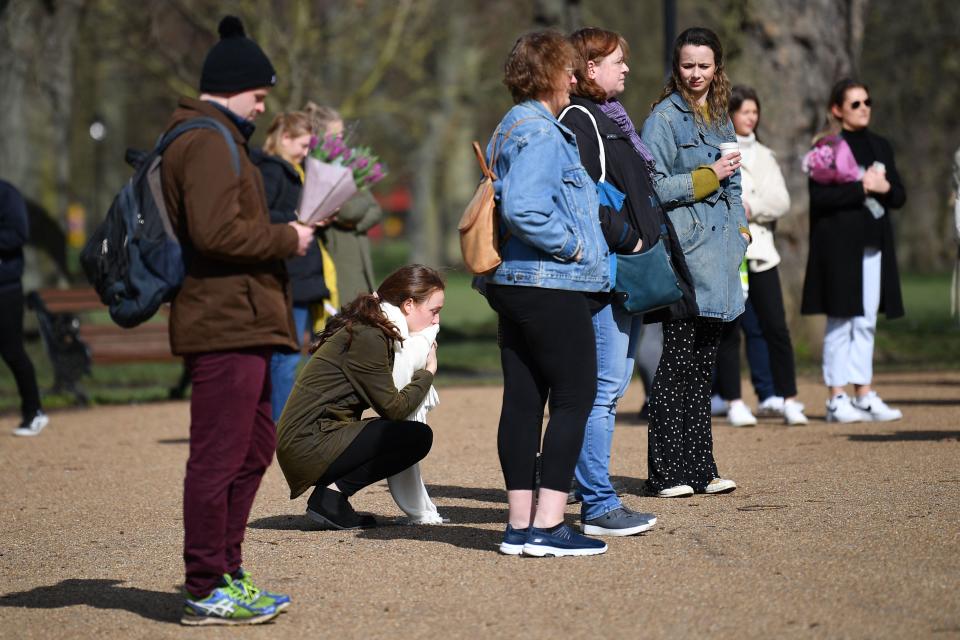 Well-wishers gather at a band-stand where a planned vigil in honour of murder victim Sarah Everard was cancelled after police outlawed it due to Covid-19 restrictions, on Clapham Common, south London on March 13, 2021, - The police officer charged with murdering  young Londoner, Sarah Everard, who disappeared while walking home from a friend's house, appeared in court on March 13, 2021, as organisers cancelled a vigil in her honour due to coronavirus restrictions. (Photo by JUSTIN TALLIS / AFP) (Photo by JUSTIN TALLIS/AFP via Getty Images)