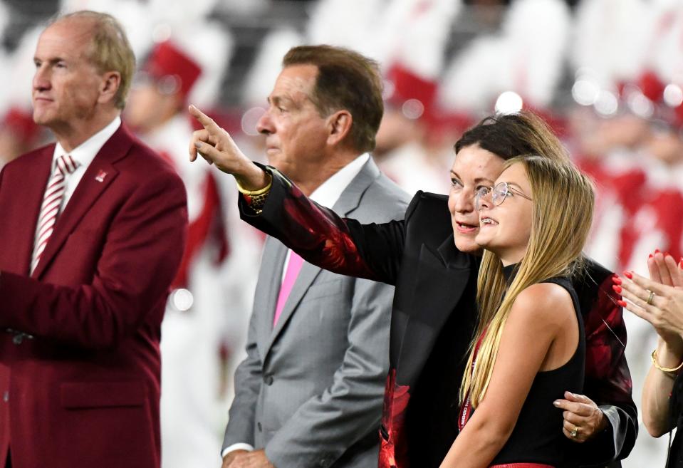 Sep 7, 2024; Tuscaloosa, Alabama, USA; Nick Saban and family are honored a half time with the renaming of the playing surface as Nick Saban Filed at Bryant-Denny Stadium. Terry Saban points out the illuminated name of the field to Amelie Saban. Mandatory Credit: Gary Cosby Jr.-Imagn Images