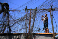 Muqtada Haider turns the switches to transfer electricity to private homes in Baghdad, Iraq, Friday, Sept. 10, 2021. In Iraq, electricity is a potent symbol of endemic corruption, rooted in the country’s sectarian power-sharing system. This contributes to chronic electrical outages of up to 14 hours a day in a major oil-producing nation with plentiful energy resources. (AP Photo/Hadi Mizban)