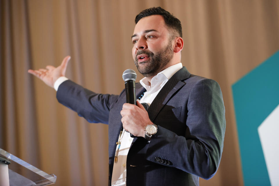 Founder and CEO of the Decolonizing Wealth Project, Edgar Villanueva, speaks during the Alight Align Arise conference on Wednesday, June 7, 2023, in Atlanta. Villanueva announced on Friday that the Decolonizing Wealth Project is committing $20 million over five years to boost campaigns run by nonprofits across the country for reparations along with a research collaboration with Boston University to map reparation projects.(AP Photo/Alex Slitz)