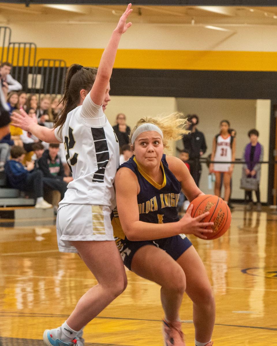 Eastern York’s Alaina Neal, right, drives around Delone Catholic’s Megan Jacoby on Saturday, Feb. 11, 2023 at Red Lion High School. Delone won the YAIAA quarterfinal 50-33.