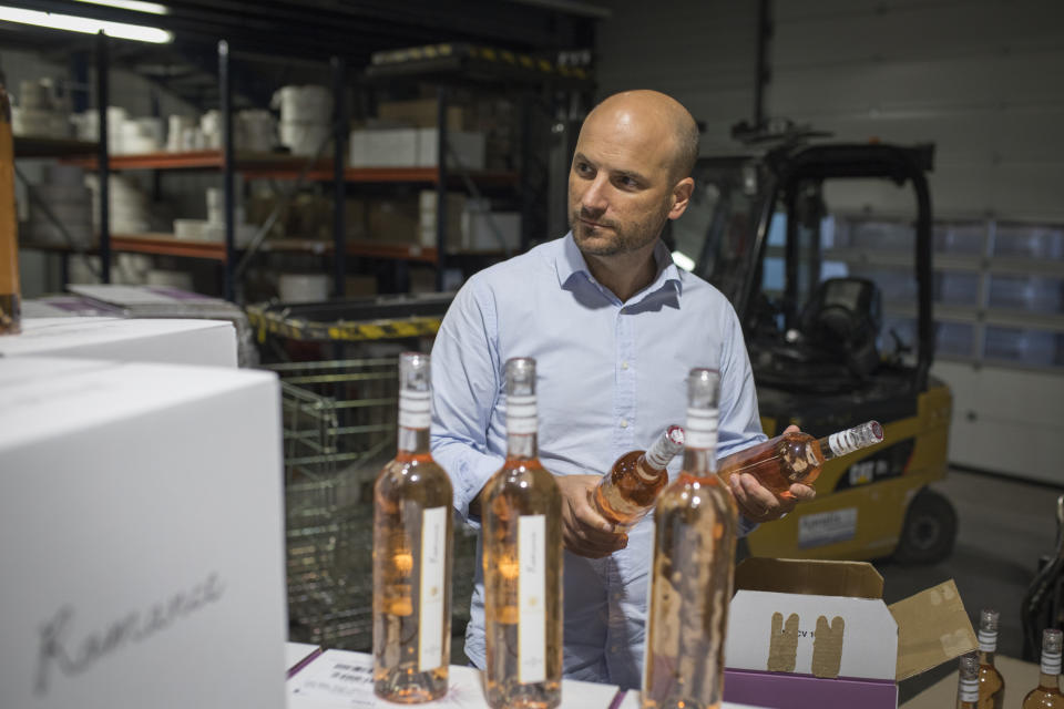 Sebastien Latz, director general of the French wine producer MDCV, inspects bottles of rosé in a wine production facility in the Chateau des Bertrands vineyard in Le Cannet-des-Maures, in the Provence region, Thursday Oct. 10, 2019. European producers of premium specialty agricultural products like French wine, are facing a U.S. tariff hike on Friday, with dollars 7.5 billion duties on a range of European goods approved by the World Trade Organization for illegal EU subsidies to aviation giant Airbus.(AP Photo/Daniel Cole)