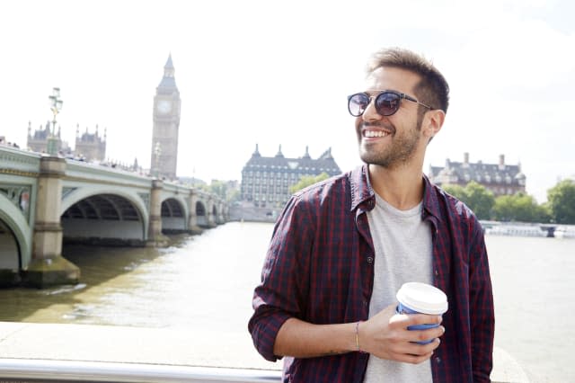 Young man with coffee in London