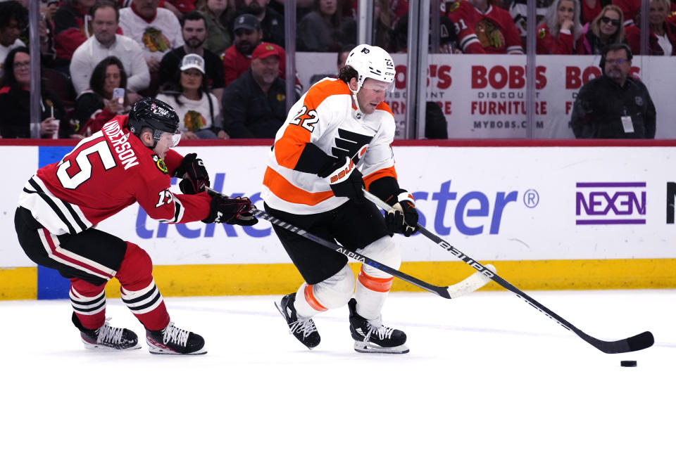 Philadelphia Flyers left wing Brendan Lemieux, right, controls the puck against Chicago Blackhawks right wing Joey Anderson during the first period of an NHL hockey game in Chicago, Thursday, April 13, 2023. (AP Photo/Nam Y. Huh)