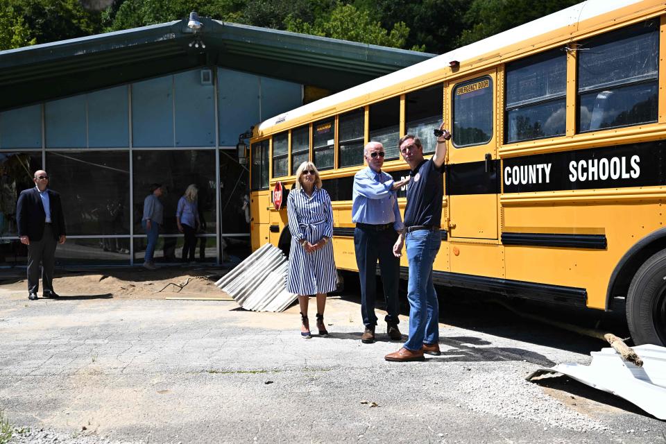 President Joe Biden, first lady Jill Biden and Kentucky Gov. Andy Beshear survey damage caused by deadly flooding on their way to a briefing on the response efforts at Marie Roberts-Caney Elementary School in Lost Creek in Breathitt County.