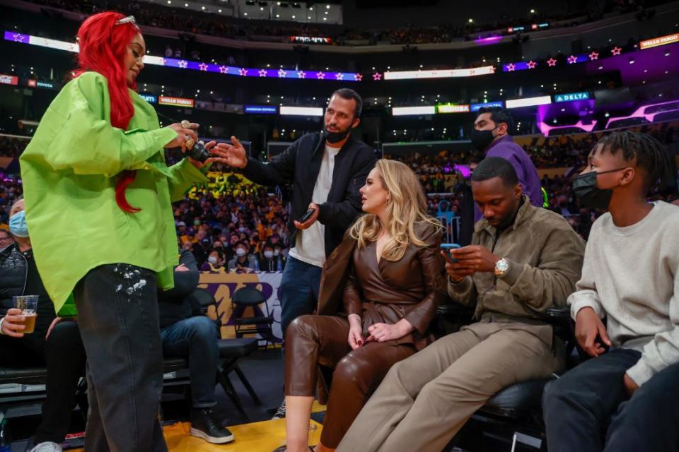 Singer Adele, left, and Rich Paul, center, attend an NBA basketball game between the Golden State Warriors and the Los Angeles Lakers in Los Angeles, Tuesday, Oct. 19, 2021. - Credit: AP