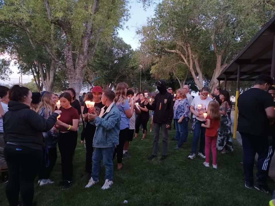 Lucerne Valley residents gather in Pioneer Park on Sunday evening, June 6, 2021, for a candlelight vigil in memory of the young victims of a hit-and-run crash in the community on Saturday.