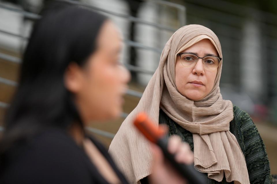 Shaimaa Zayan, with the Council on American-Islamic Relations in Austin, listens at a City Hall news conference Tuesday as Akeela Kongdara, of Asian Texans for Justice, talks about an alleged hate crime against a Muslim University of Texas student last week.