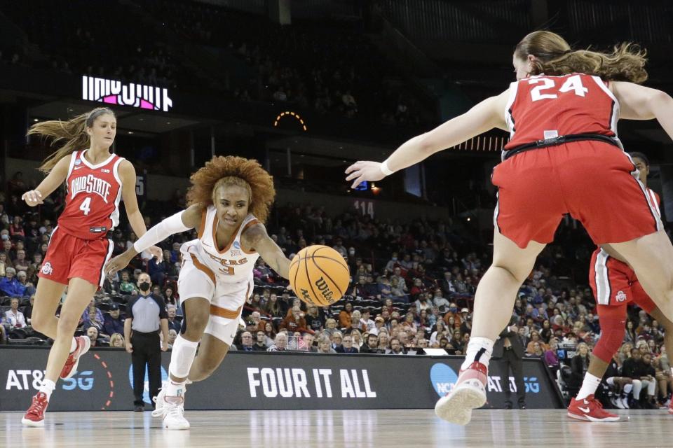 Texas point guard Rori Harmon reaches for a loose ball between Ohio State guards Taylor Mikesell, right, and Jacy Sheldon during the first half. Harmon battled foul trouble throughout the game but made two key free throws in the closing seconds.