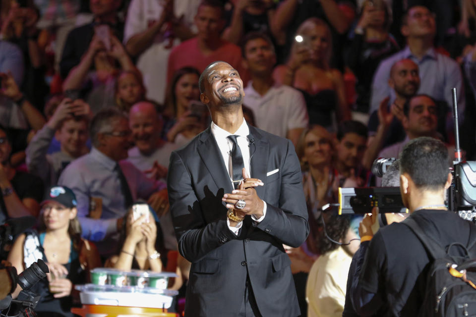 Former Miami Heat player Chris Bosh reacts after being introduced at the team's retirement of his jersey at halftime of an NBA game between the Heat and the Orlando Magic, Tuesday, March 26, 2019, in Miami. Bosh played 13 seasons, the first seven in Toronto and the last six in Miami. He averaged 19.2 points and 8.5 rebounds, was an All-Star 11 times and won two championships.(AP Photo/Joe Skipper)