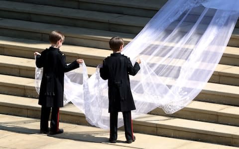 Mulroney twins hold Meghan Markle's veil - Credit: Andrew Matthews/PA