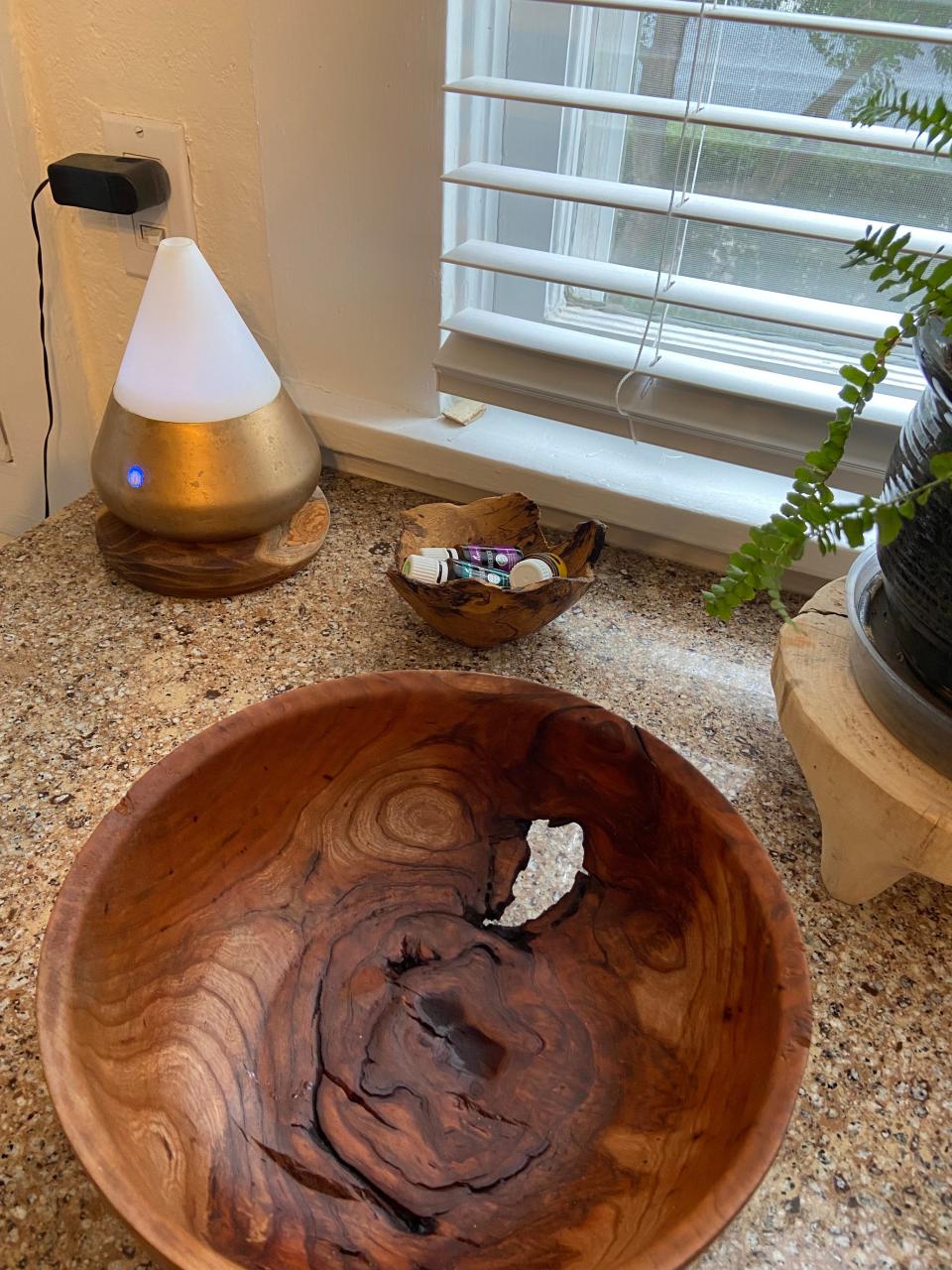 A piece of cherry wood was carved and shaped into a bowl that stays in Stephen Holmes' kitchen along with an oil diffuser stand, a small bowl to hold essential oils and a plant stand.