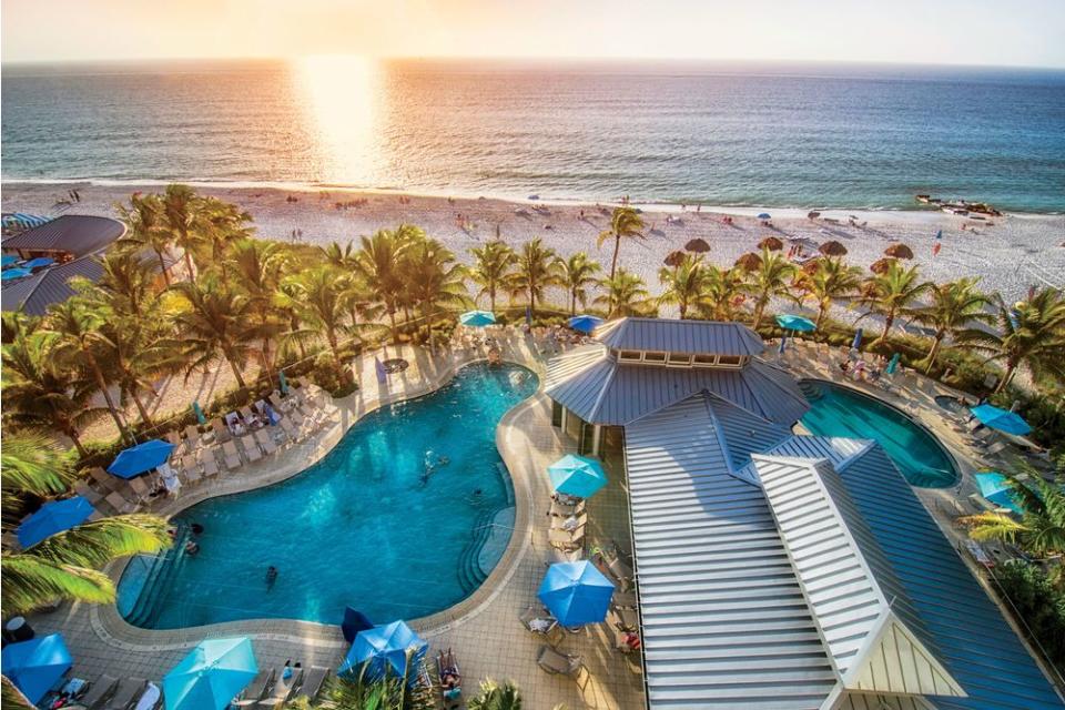 The white-sand meeting of pool and Gulf at The Naples Beach Hotel & Golf Club | Courtesy of The Naples Beach Hotel & Golf Club