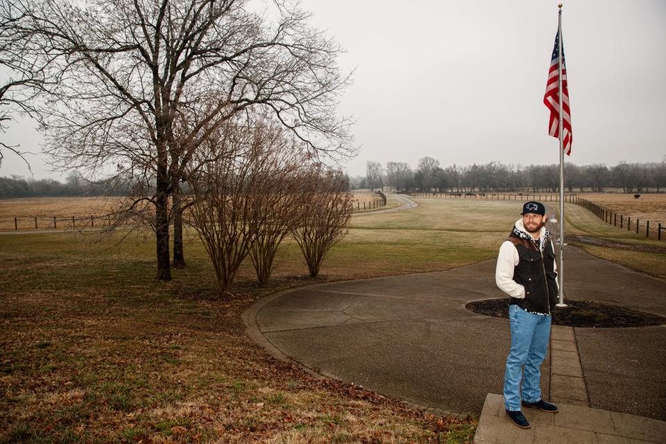 Chase Rice stands in front of a flag pole at the entrance to his home in Franklin, Tenn. on Feb. 1, 2023.