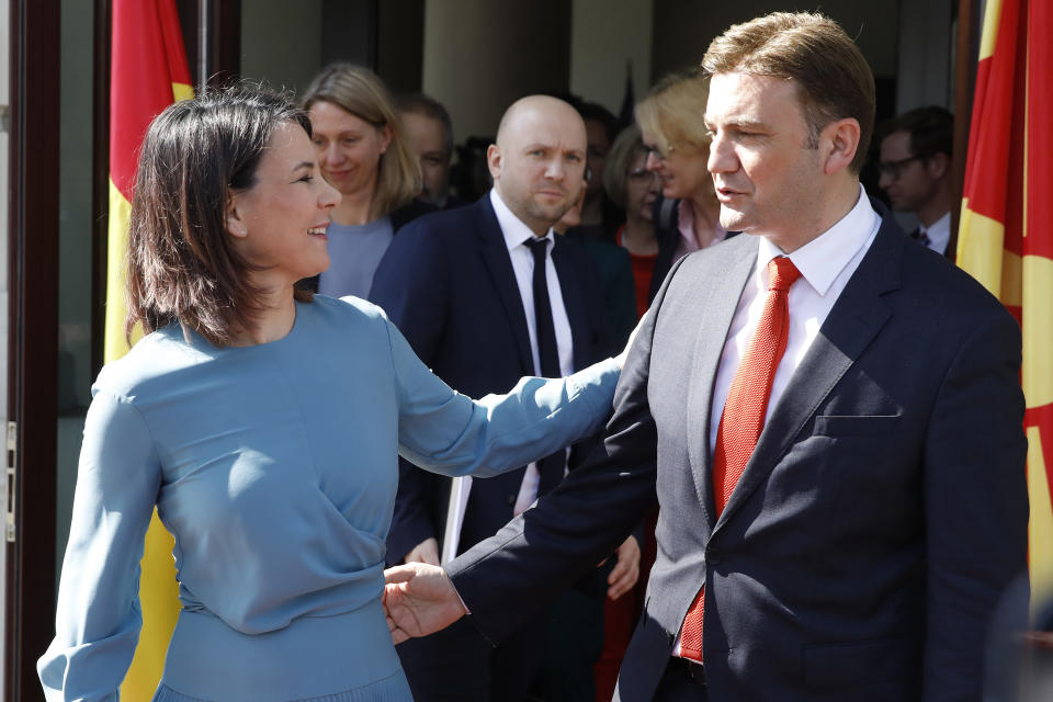 German Foreign Minister Annalena Baerbock, left, greets her North Macedonia's counterpart Bujar Osmani, following their meeting at the foreign ministry in Skopje, North Macedonia, on Thursday, March 23. 2023. (AP Photo/Boris Grdanoski)