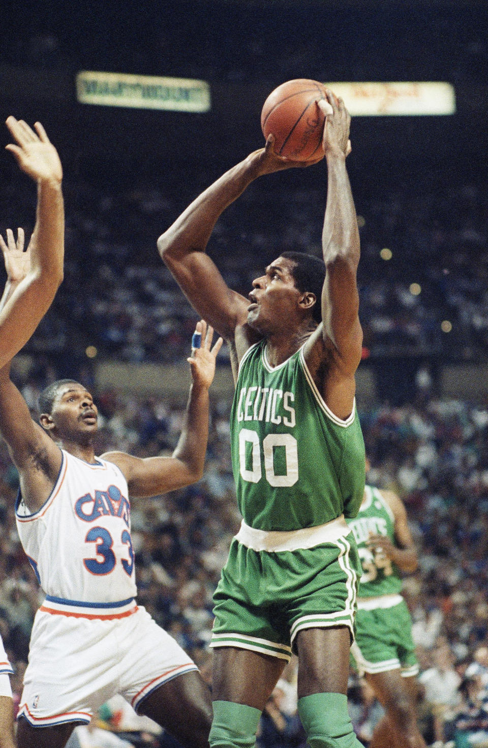 Boston Celtics center Robert Parish (00) shoots over Mike Sanders (33) of the <a class="link " href="https://sports.yahoo.com/nba/teams/cleveland/" data-i13n="sec:content-canvas;subsec:anchor_text;elm:context_link" data-ylk="slk:Cleveland Cavaliers;sec:content-canvas;subsec:anchor_text;elm:context_link;itc:0">Cleveland Cavaliers</a> during the first quarter of their second-round NBA playoff game at the Richfield Coliseum in Richfield, Ohio, May 4, 1992. The Cavs lead the series 1-0. AP Photo/Jeff Glidden