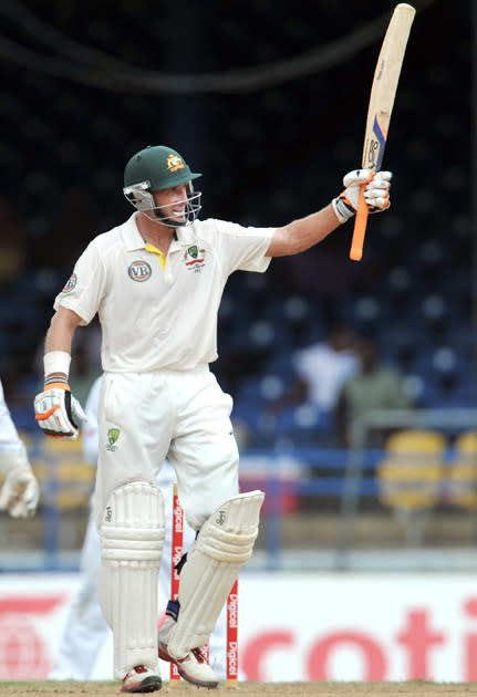 Australian batsman Michael Hussey acknowledges the crowd after getting his 50th run during the second day of the second-of-three Test matches between Australia and West Indies April 16, 2012 at Queen's Park Oval in Port of Spain. AFP PHOTO/Stan HONDA