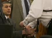 A court officer places handcuffs on the wrists of former NFL player Aaron Hernandez after the guilty verdict was read during his murder trial at the Bristol County Superior Court in Fall River, Massachusetts, April 15, 2015. Hernandez, 25, a former tight end for the New England Patriots, is convicted of fatally shooting semiprofessional football player Odin Lloyd in an industrial park near Hernandez's Massachusetts home in June 2013. REUTERS/Dominick Reuter TPX IMAGES OF THE DAY